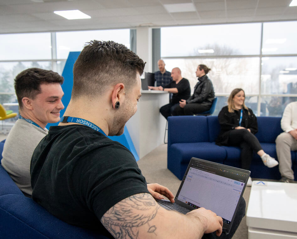 Two employees reviewing work